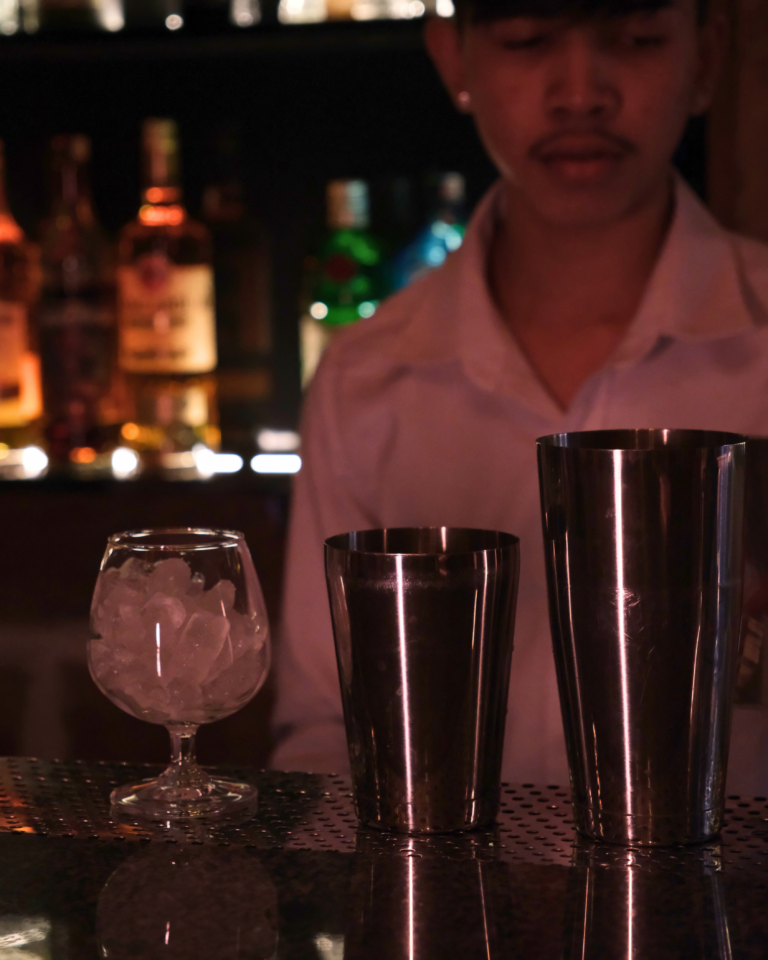 Bartender preparing drinks behind the bar
