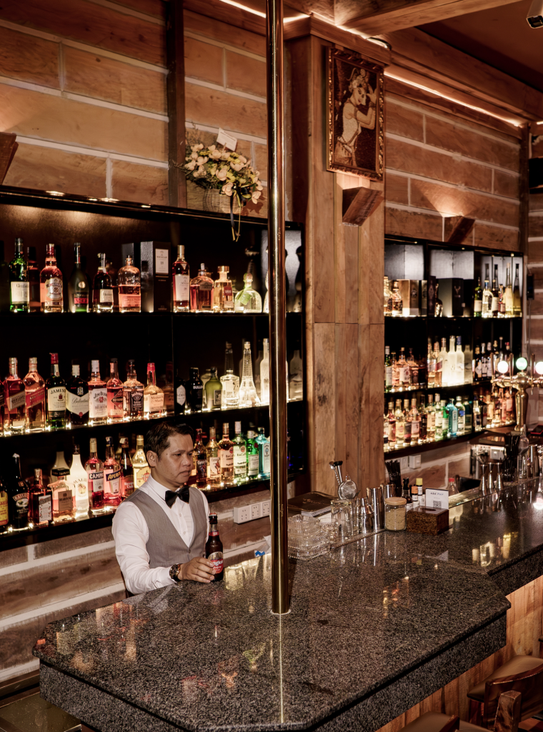 Cozy wooden bar interior with warm lighting and seating arranged along the walls